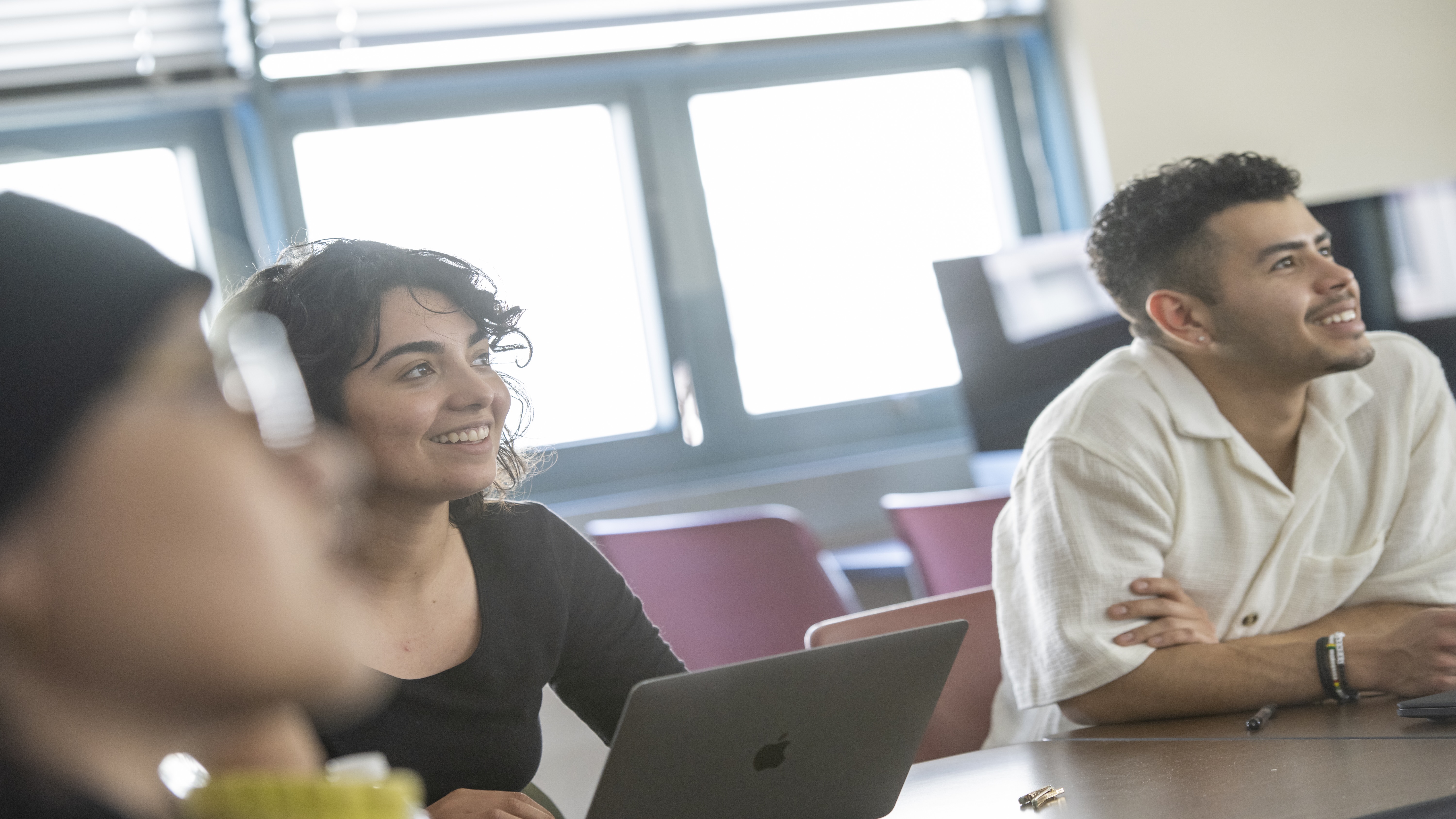 students listening to a lecture smiling