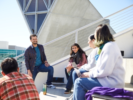 students outside learning about campus from a campus leader